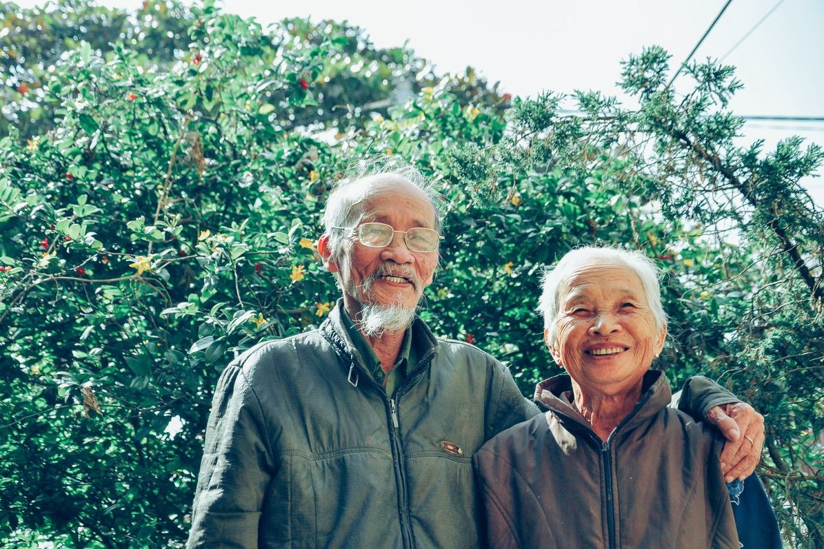 A smiling older couple outdoors — gift ideas for grandparents