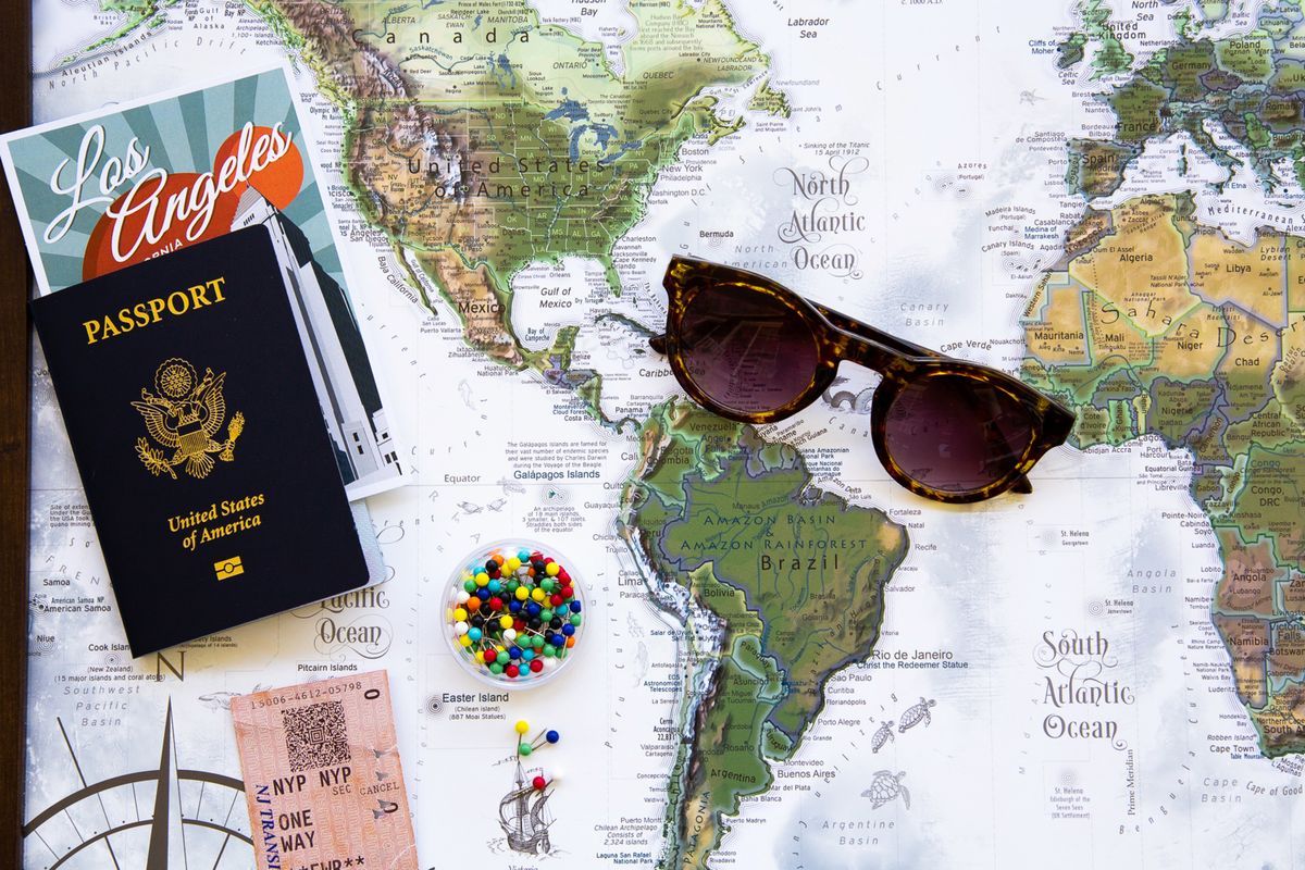 A passport and world map travel flat-lay — travel gift ideas for seniors